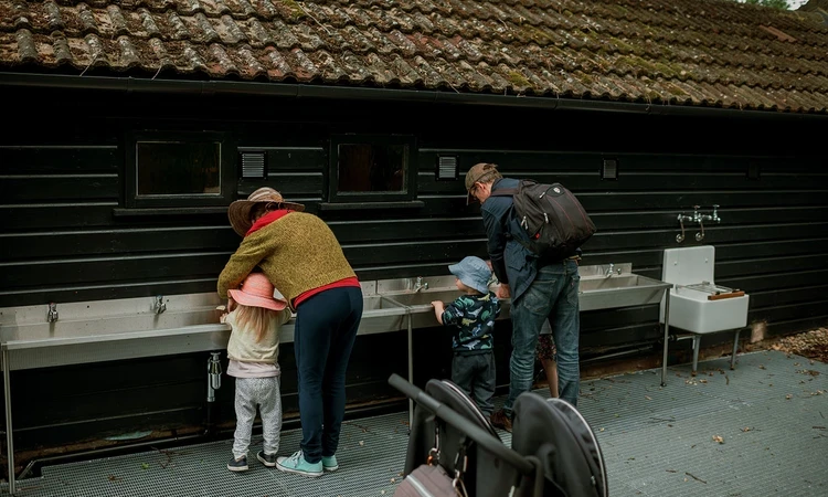 People using the outdoor washing area at the Learning Centre