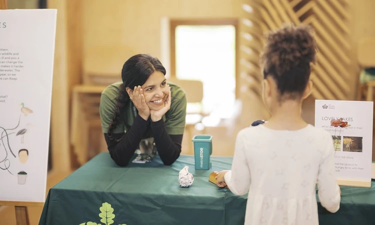 Community Engagement Officer Cassie talking to a young girl