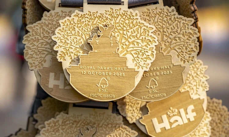 Close-up photo of a wooden race medal shaped like a leaf