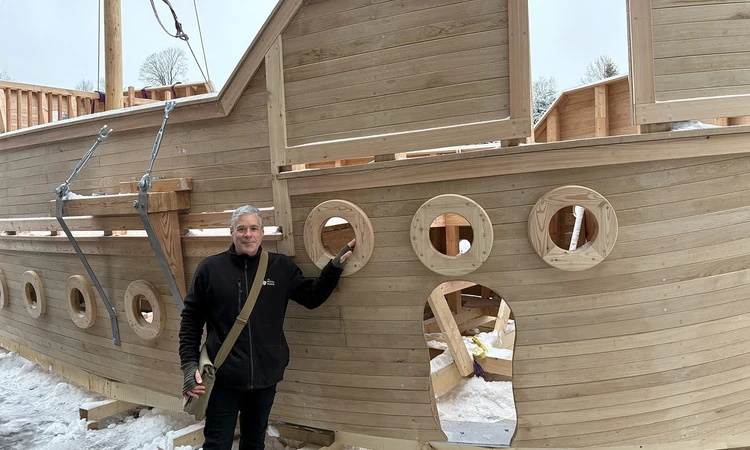 Andy Williams stands beside the new wooden play galleon