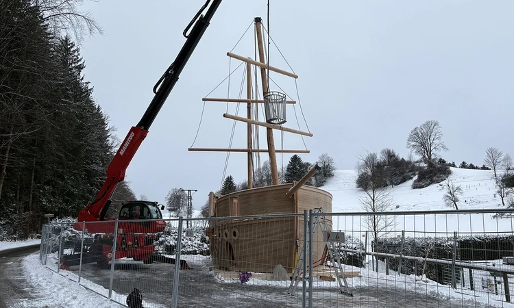 Crows nest being lowered by crane onto the wooden play galleon