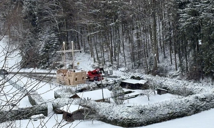 The new wooden play galleon nestled in front of a snowy forest