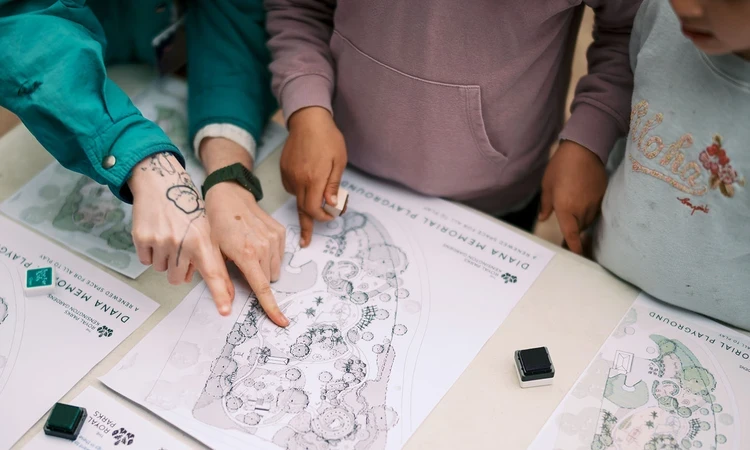 Youngsters point at features of the new playground design