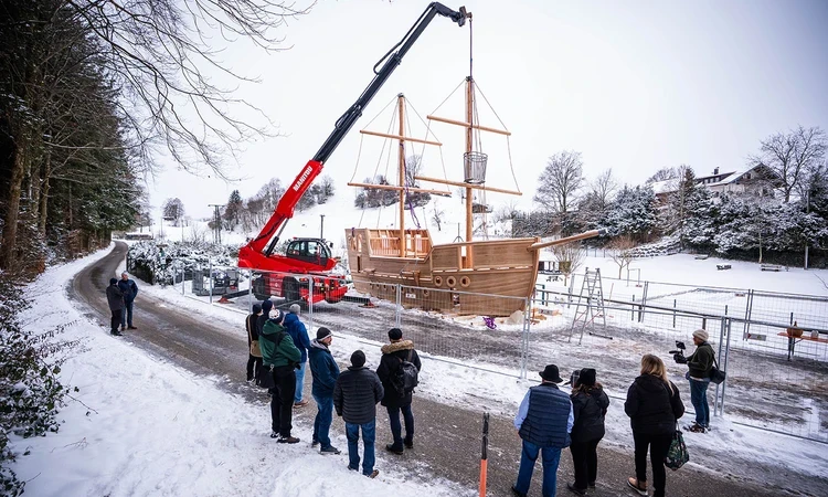 A crane lowers the crows nest in place on the new play galleon