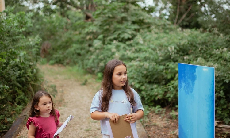 Two young girls looking at a pinhole camera photo