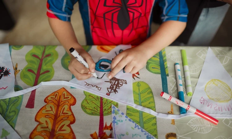 Young child decorating bunting