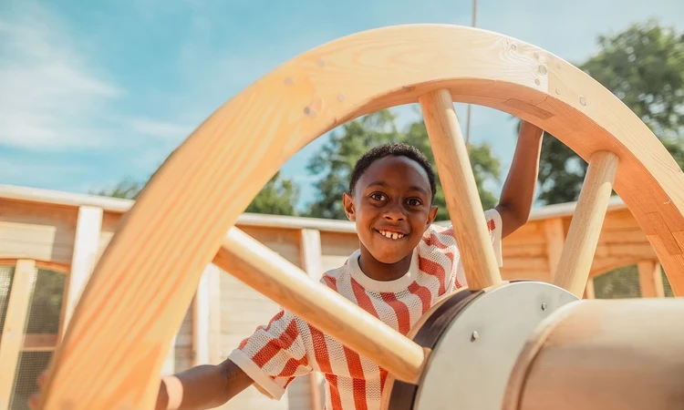 Young boy at the ship's wheel