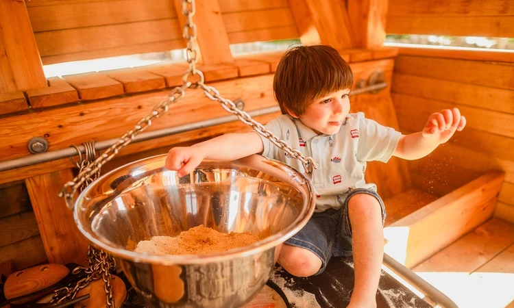 Young boy playing with sand