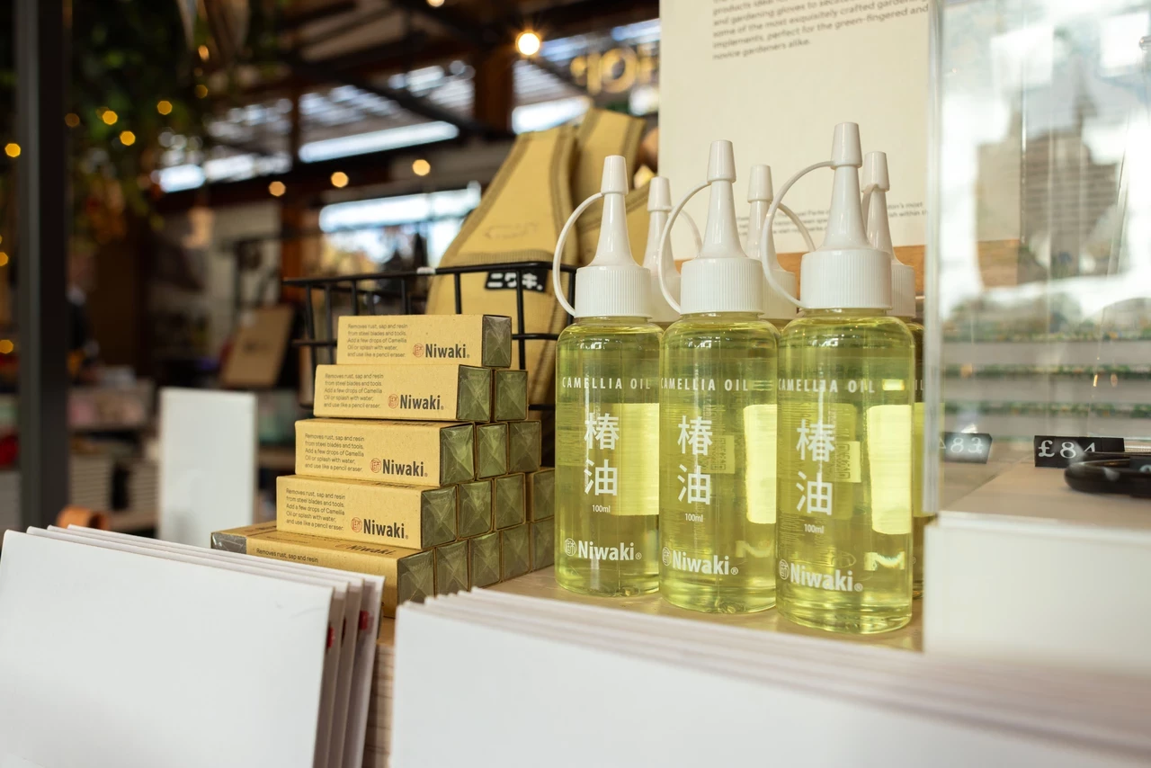 Stacked bottles of Camellia Oil on display in the TRP Shop