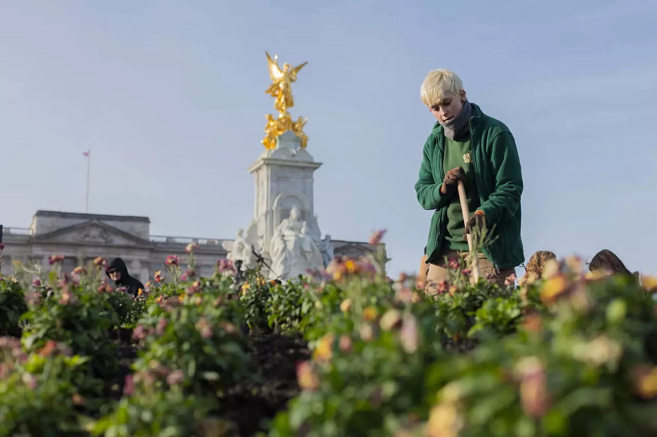 Apprentice Jasmine Talbot-Cooper tending the flower beds outside Buckingham Palace