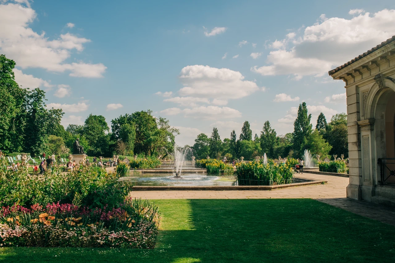 Landscape image of a garden with a fountain in between