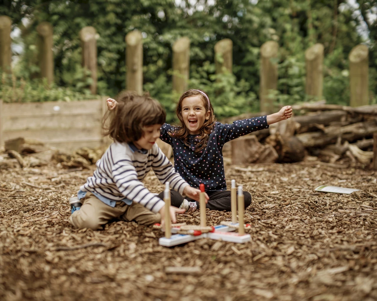 Image of two children playing outdoors in a yard