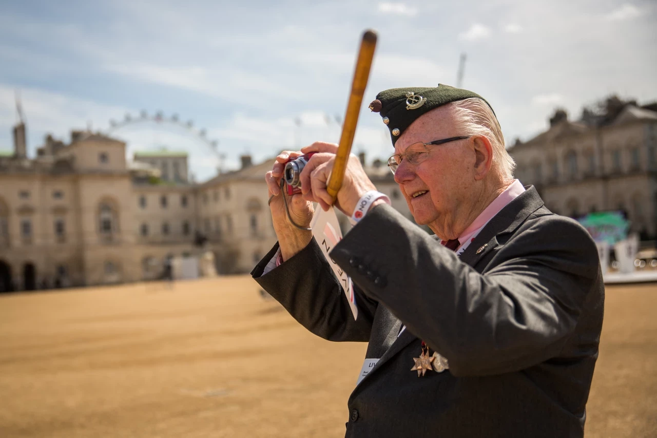 A Second World War veteran takes a photograph ahead of the 70th Anniversary commemorations of VJ Day (Victory over Japan) at Horse Guards Parade in August 2015