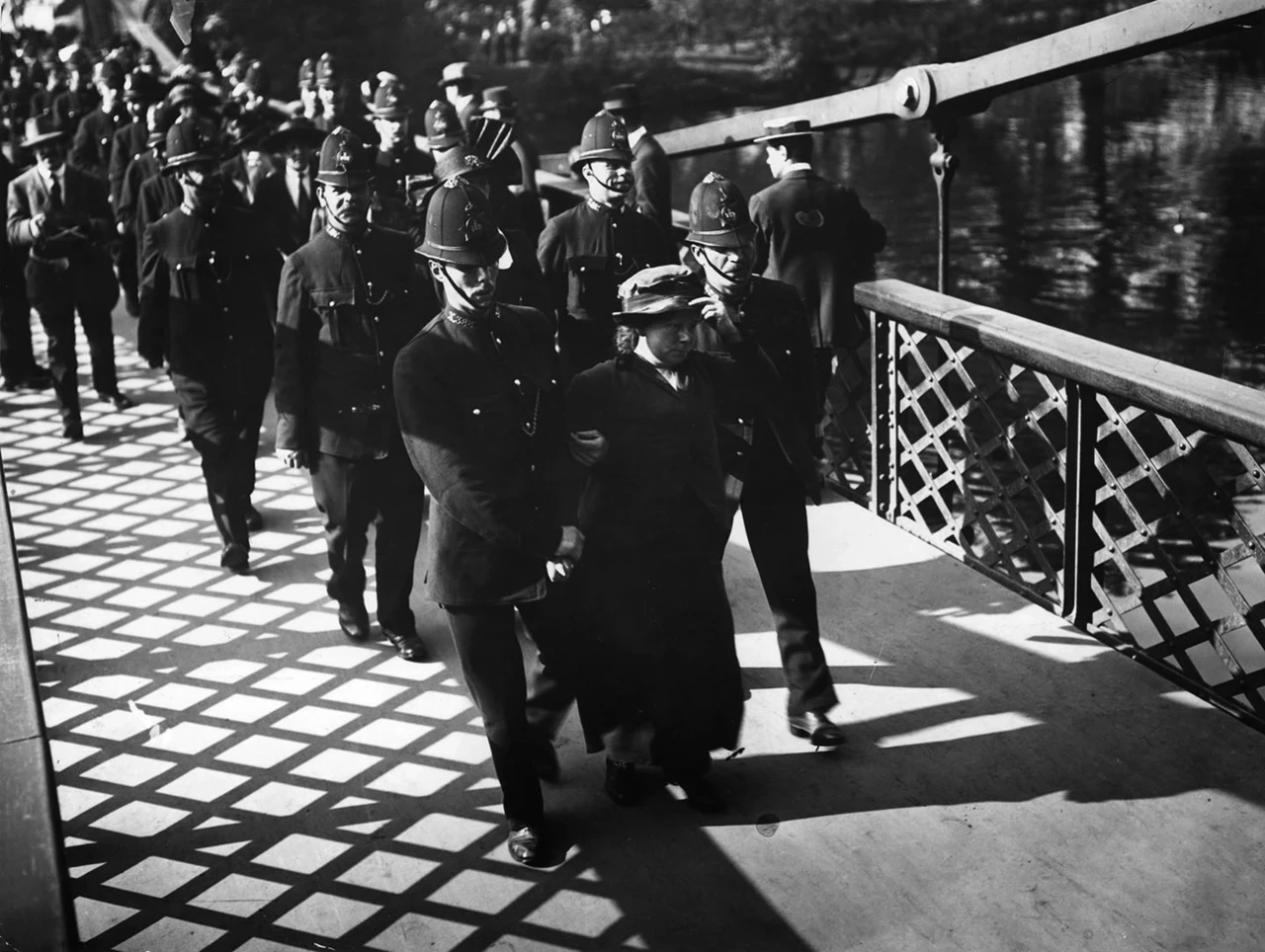 Police escort suffragettes across the Blue Bridge, 21 May 1914.