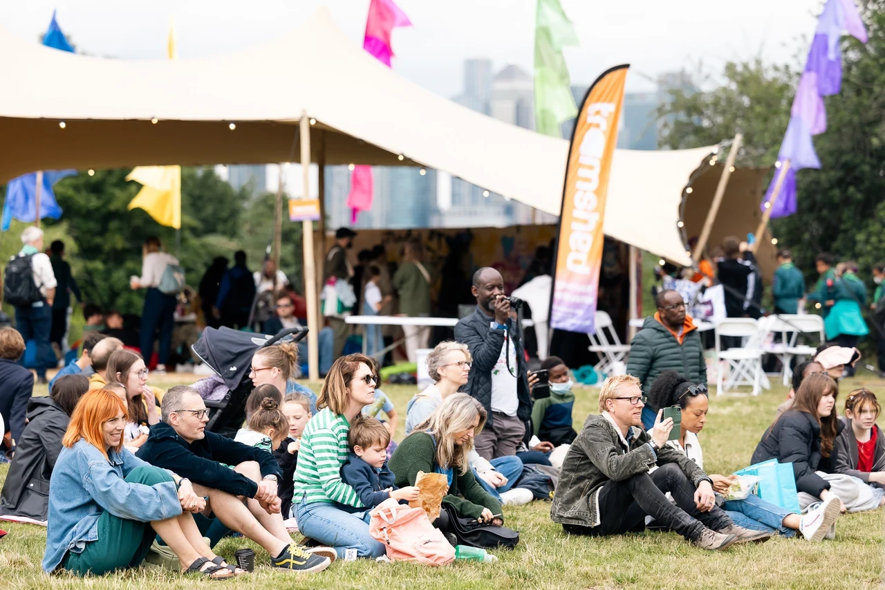Image of people sitting on the grass in an outdoor sitting.