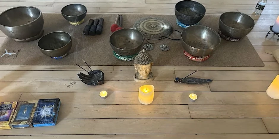 Image of several bowls and candles laid out on a wooden tabletop.
