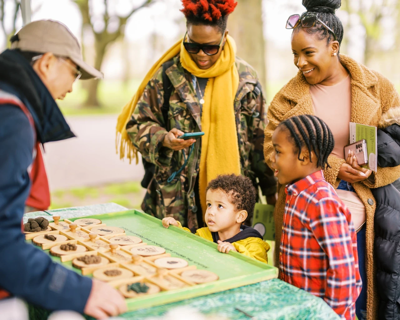 A family playing a quiz matching fake poos to the animal who do them