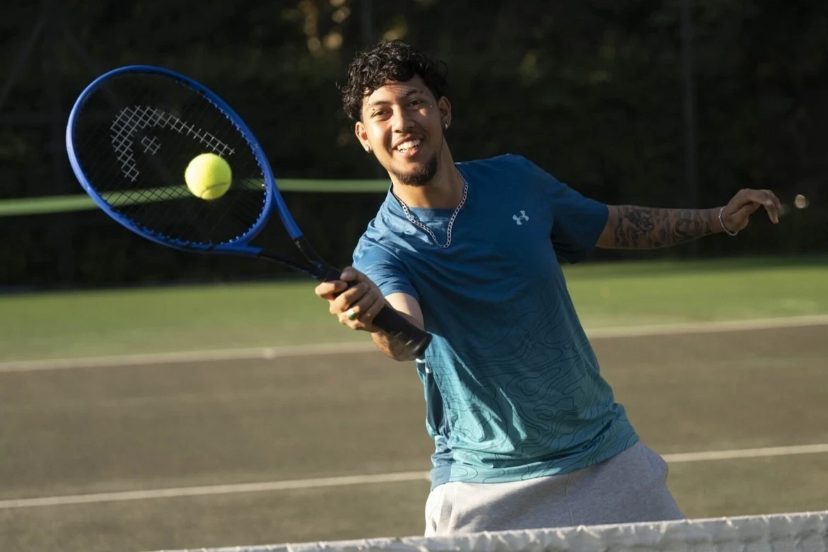 Man playing tennis at The Courts in the Royal Parks