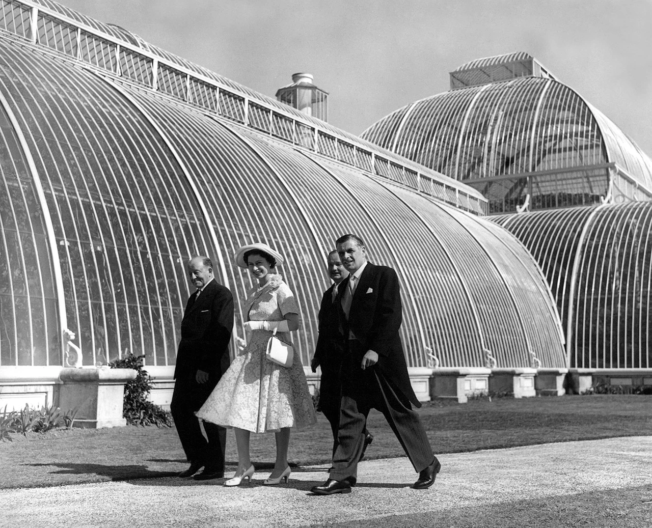 Queen Elizabeth II walking past the Palm House during her tour of Kew Gardens