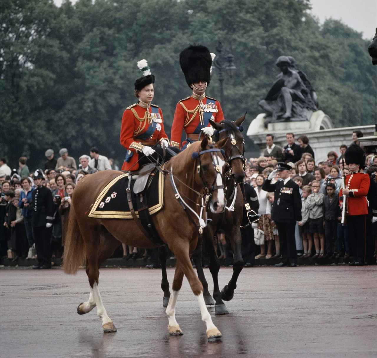 Queen Elizabeth II and Prince Philip return to Buckingham Palace on horseback