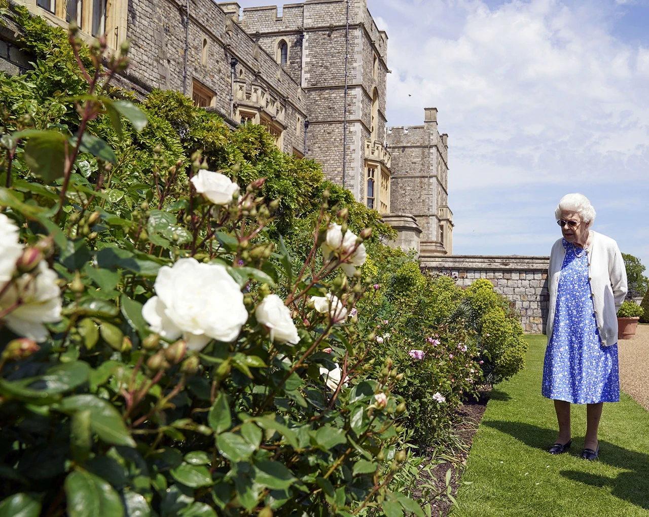 Queen Elizabeth II views a flower bed in the grounds of Windsor Castle