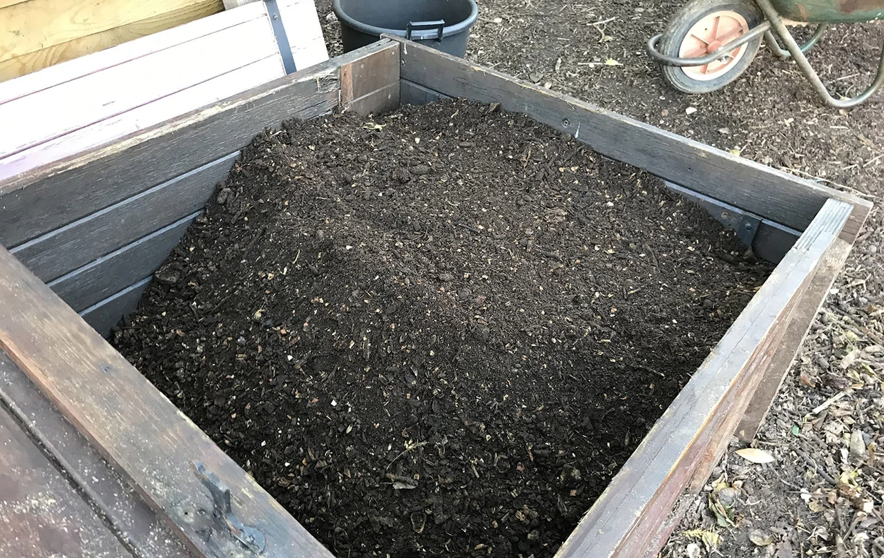 Garden compost in a wooden compost bin