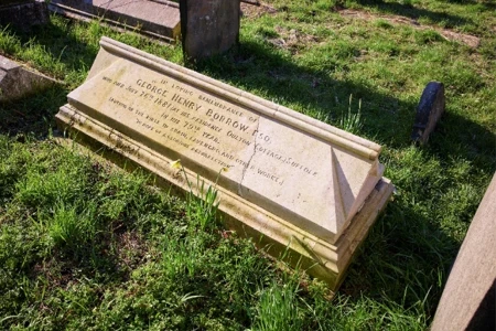 long chest tomb in a bed of green grass